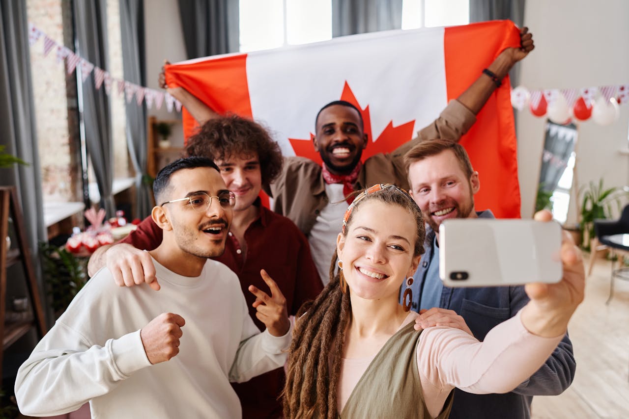 Crafting Captivating Headlines: Your awesome post title goes here A diverse group of friends celebrating Canada Day with a joyful selfie indoors.